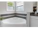 Inviting bathroom showcasing a garden tub and accent mosaic tile surround at 900 Hillary Ln, Lawrenceville, GA 30043