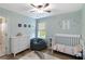Serene Bedroom featuring a white crib, dresser, and charming decor at 900 Hillary Ln, Lawrenceville, GA 30043