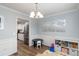 Light-filled dining area features modern lighting, sleek wall trim, and easy access to the kitchen at 900 Hillary Ln, Lawrenceville, GA 30043