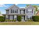 Charming two-story home with gray siding, black shutters, manicured lawn, and a welcoming front porch at 900 Hillary Ln, Lawrenceville, GA 30043