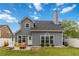 Exterior shot of the home showcasing a well-manicured yard and patio area at 900 Hillary Ln, Lawrenceville, GA 30043