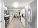 Bright kitchen features white cabinets, stainless steel appliances and a view to the dining area at 900 Hillary Ln, Lawrenceville, GA 30043
