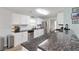 Bright kitchen features white cabinetry, stainless steel appliances, and dark granite countertops with bar seating at 900 Hillary Ln, Lawrenceville, GA 30043