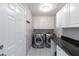 Functional laundry room with modern washer and dryer, plus ample storage at 900 Hillary Ln, Lawrenceville, GA 30043