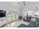 Open-concept living room with a fireplace, large windows, and seamless flow to dining and kitchen areas at 900 Hillary Ln, Lawrenceville, GA 30043