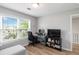 Inviting living room with a bright window, desk, and entertainment area at 900 Hillary Ln, Lawrenceville, GA 30043