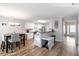 Open plan living area features white cabinets, stainless steel appliances and view into dining room at 900 Hillary Ln, Lawrenceville, GA 30043