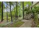 View of the backyard and wooded lot with stairs leading to the back of the house at 9295 Martin Rd, Roswell, GA 30076