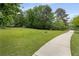 Well-maintained backyard with a concrete path, offering a serene escape with lush greenery at 9295 Martin Rd, Roswell, GA 30076