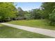 Expansive backyard with a concrete walkway, fenced area, and plenty of space for recreation at 9295 Martin Rd, Roswell, GA 30076