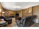 Cozy basement living area with wood paneling, comfortable seating, and entertainment center at 9295 Martin Rd, Roswell, GA 30076