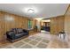 View of the basement area showing wood paneling, tile floor, and decorative rug at 9295 Martin Rd, Roswell, GA 30076
