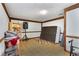 Unfinished basement space with exposed beams, tile floors, and storage shelving at 9295 Martin Rd, Roswell, GA 30076