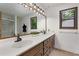 Spacious bathroom featuring double sinks, a large mirror, and natural lighting at 9295 Martin Rd, Roswell, GA 30076