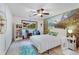 Well-lit bedroom with mountain wallpaper, ceiling fan, and a comfortable white bed at 9295 Martin Rd, Roswell, GA 30076