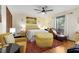 Comfortable bedroom featuring a ceiling fan, natural light, and a sitting area at 9295 Martin Rd, Roswell, GA 30076
