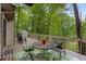 Outdoor deck with patio furniture and green leafy trees in the background at 9295 Martin Rd, Roswell, GA 30076