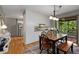 Dining area boasts hardwood floors, ample lighting, and seamless flow into the kitchen and screened-in porch at 9295 Martin Rd, Roswell, GA 30076