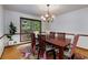 Charming dining room with hardwood floors, a chandelier, and large windows offering serene outdoor views at 9295 Martin Rd, Roswell, GA 30076