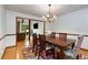 Elegant dining room featuring hardwood floors, chandelier lighting, and an open view into the adjacent living area at 9295 Martin Rd, Roswell, GA 30076
