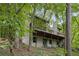 Exterior view of the home's back with deck, screened porch, and wooded surroundings at 9295 Martin Rd, Roswell, GA 30076