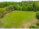 Aerial view of a large green space bordered by trees, ideal for recreation or future development at 9295 Martin Rd, Roswell, GA 30076