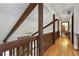 Hallway with wood floors and exposed beams, providing architectural detail and charm at 9295 Martin Rd, Roswell, GA 30076