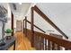 Second-floor hallway featuring exposed beams, hardwood floors, and an open view of the living room below at 9295 Martin Rd, Roswell, GA 30076