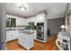 Functional kitchen featuring white cabinets, stainless steel appliances, and an island, complemented by hardwood floors at 9295 Martin Rd, Roswell, GA 30076
