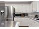 White kitchen featuring stainless steel appliances and light countertops at 9295 Martin Rd, Roswell, GA 30076