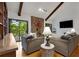 Cozy living room features hardwood floors, vaulted ceilings with wood beams, and a striking stone fireplace at 9295 Martin Rd, Roswell, GA 30076