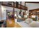 Open-concept living space featuring hardwood floors, a balcony, and views into the adjacent dining room at 9295 Martin Rd, Roswell, GA 30076