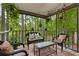Inviting screened-in porch with comfortable wicker furniture and string lights at 9295 Martin Rd, Roswell, GA 30076