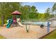 Community playground with colorful play structure, slides, and surrounding green space next to the pool at 9295 Martin Rd, Roswell, GA 30076