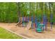 Community playground with colorful equipment surrounded by trees, creating a fun and safe play area at 9295 Martin Rd, Roswell, GA 30076
