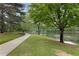 Scenic view of a pond with a walking path and lush green trees, perfect for relaxing strolls at 9295 Martin Rd, Roswell, GA 30076