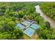 Aerial view of multiple tennis courts surrounded by lush greenery, offering ample recreational opportunities at 9295 Martin Rd, Roswell, GA 30076