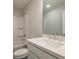 Modern bathroom featuring a white vanity, a large mirror, and a clean, bright bathtub with shower at 166 Bluffington Way, Marietta, GA 30066