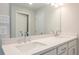 Bright bathroom with double sinks, a large mirror and sleek hardware at 166 Bluffington Way, Marietta, GA 30066