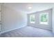 Bright bedroom with two windows, carpet flooring and neutral wall color, ideal for relaxation at 166 Bluffington Way, Marietta, GA 30066