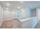 Well-lit hallway with wood floors, white trim, and access to other rooms, offering a seamless transition at 166 Bluffington Way, Marietta, GA 30066