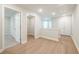 Bright hallway with wood floors, leading to bedrooms and laundry with an access panel to attic at 166 Bluffington Way, Marietta, GA 30066