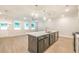 Bright open kitchen with island, stainless steel appliances, and seamless access to dining area at 166 Bluffington Way, Marietta, GA 30066