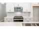 Modern kitchen features stainless steel appliances, white cabinets, and granite countertops at 166 Bluffington Way, Marietta, GA 30066