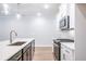 Island with sink and appliances, white cabinets and granite countertops in a modern kitchen at 166 Bluffington Way, Marietta, GA 30066