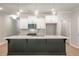 Elegant kitchen with a black center island, stainless steel appliances, and white cabinetry at 166 Bluffington Way, Marietta, GA 30066