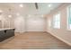 An open-concept space featuring vinyl floors, ceiling fan, and a view into the kitchen, perfect for entertaining at 166 Bluffington Way, Marietta, GA 30066
