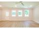 A light-filled living room with new vinyl floors and ceiling fan, showcasing its spaciousness and modern design at 166 Bluffington Way, Marietta, GA 30066