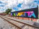 Colorful mural in downtown Marietta. The side of a building is graffitied with a colorful Marietta sign at 166 Bluffington Way, Marietta, GA 30066