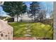 Expansive backyard features lush lawn, stepping stones, and mature trees for outdoor enjoyment at 1763 Delaware Ne Ave, Atlanta, GA 30307